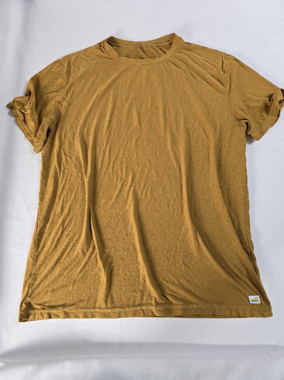 Vuori short-sleeve performance t-shirt featured in a mustard or golden brown ton